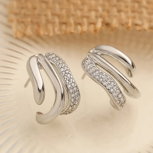 Irregular geometric zircon stud earrings with triple layered silver streamline design