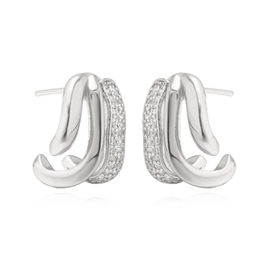 Detailed macro view of silver-tone irregular layered earrings with inlaid white zircons