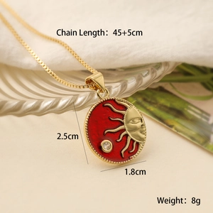 Detailed view of sun relief necklace with gold plating and red enamel finish