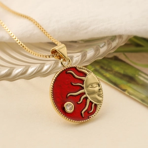 Vintage gold plated sun face necklace with red enamel pendant and zirconia detail