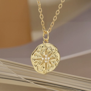 Minimalist 18K gold plated copper necklace with textured starburst circular pendant