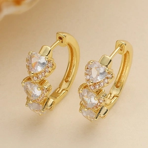 Macro shot of 18K gold plated hoop earrings featuring three sparkling zircon hearts