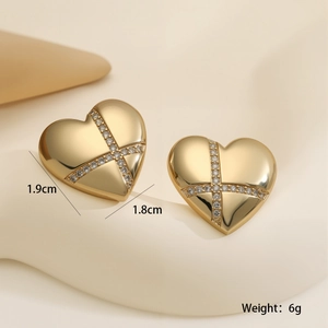 Macro shot of gold heart earrings with cross inlay detail and size specs 1.9cm x 1.8cm