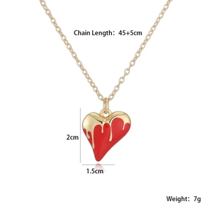 Detail view of red enamel heart pendant necklace with dimensions 2cm by 1.5cm
