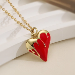 Minimalist 18K gold plated necklace featuring a melting red enamel heart pendant design