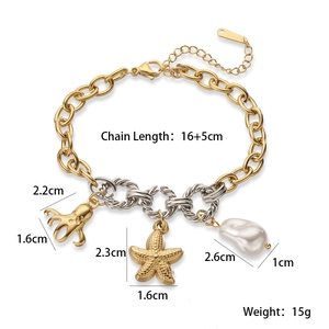 Macro detail of 18K gold plated octopus and starfish charms on a mixed link steel bracelet