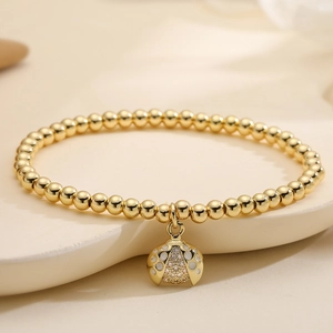 Élégant bracelet à billes plaqué or 18 carats avec pendentif coccinelle en zircon brillant
