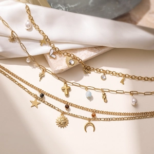 Layered 18K gold-plated stainless steel necklace with sun cross and pearl charms