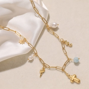 Vintage 18K gold plated stainless steel sun and cross charm necklace on white silk