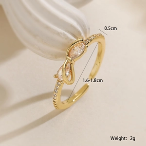 Macro shot of gold-plated bow ring with pear-cut zircon and adjustable band size details
