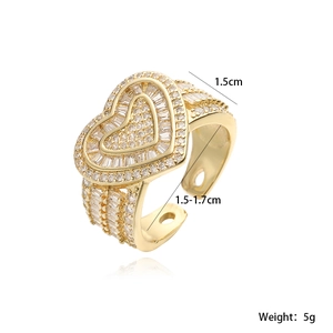 Macro shot of 18K gold plated heart ring with baguette and round cubic zirconia details