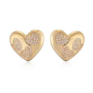 Macro shot of gold-plated heart studs featuring sparkling white zircon inlay details