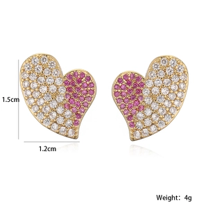Detail view of gold heart stud earrings with pink zircon stones including dimensions