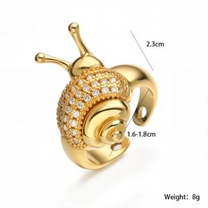 Detailed view of golden snail shell ring with zircon inlay and 2.3cm height dimension