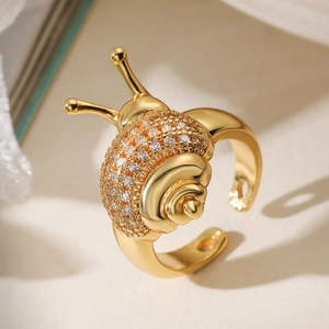 Unique snail shell open ring in gold with sparkling white crystal pavé setting