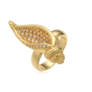 Macro shot of gold-plated leaf ring showing micro-pave cubic zirconia and grain texture