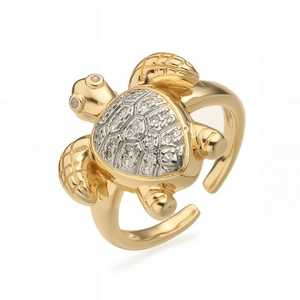 Macro shot of gold-plated turtle ring with silver zircon shell and adjustable open band