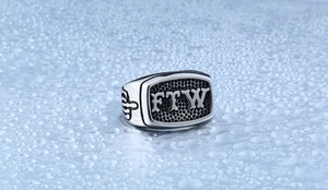 Macro view of vintage titanium steel ring with FTW gothic engraving and side relief