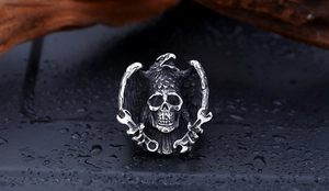 Detailed macro view of vintage stainless steel biker ring with eagle and skull design