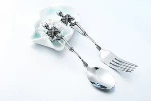 Detailed view of Gothic skull silverware set showing skeleton handle and vintage silver finish