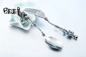 Macro shot of gothic skull handle details on vintage stainless steel fork and spoon set