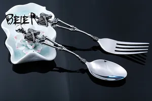 Close-up of skeleton-themed stainless steel flatware set with bone shaped handles