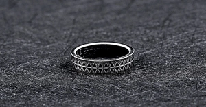 Detailed macro view of vintage silver ring featuring geometric triangle engravings