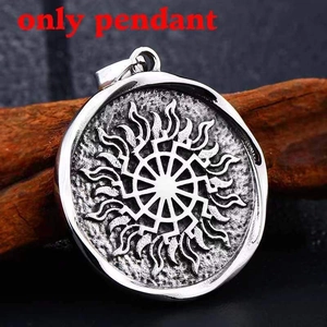 Detailed macro view of the silver stainless steel Black Sun pendant on wood