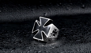 Macro shot of vintage stainless steel men's ring with black enamel iron cross detail