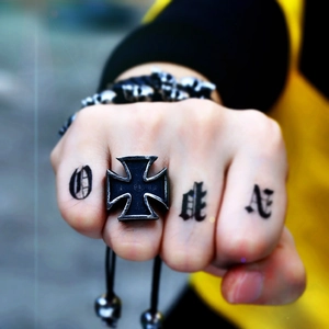 Detail of vintage stainless steel Iron Cross ring for men with punk style aged finish