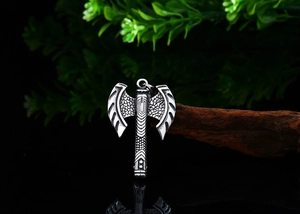 Macro detail of Nordic Viking double-headed axe pendant with vintage tribal engravings