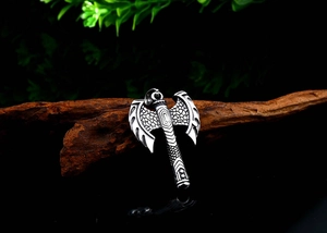 Detailed close-up of a Norse Viking axe pendant featuring intricate scale textures
