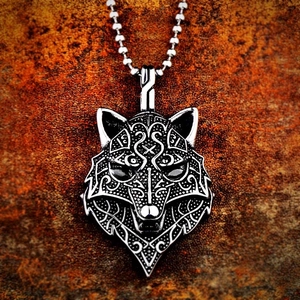 Macro shot of Viking wolf head pendant with punk textures and silver bead chain