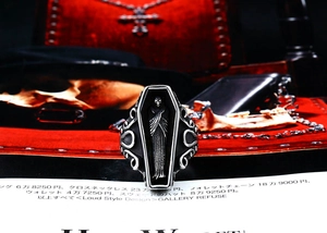 Detailed close-up of Gothic coffin ring featuring skeleton relief and filigree design