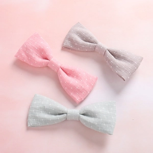 Three soft cotton bow hair clips with star patterns in pink, grey, and blue colors