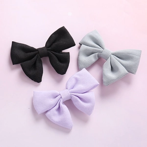Three-piece linen bow hair clip set in black, grey, and purple for girls and children
