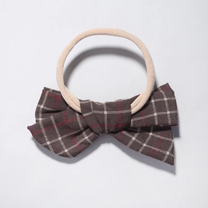 Detail of baby nylon headband with coffee brown plaid bow and soft elastic band