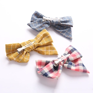Detailed view of handmade linen plaid bow hair clips with sturdy metal alligator back clips