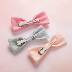Three-piece set of cotton fabric bow hair clips for babies in pink, grey, and orange