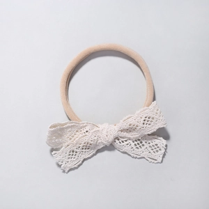 Soft nylon baby headband featuring an elegant white lace hollow butterfly bow design