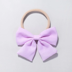 Detail of the soft striped purple bow and stretchy nylon headband for infants