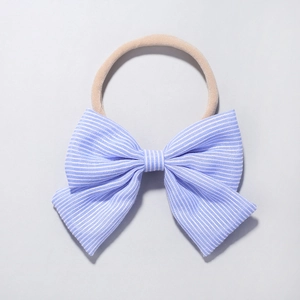 Detail of baby striped bow headband made of light blue fabric and nude nylon band