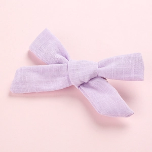 Close-up of light purple bow hair clip showing high-quality cotton linen fabric texture