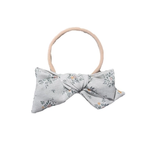 Floral print bow headband for babies with soft elastic nylon band on white background