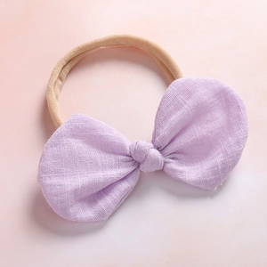 Close-up of lilac linen bow baby headband with soft high-elastic seamless nylon strap