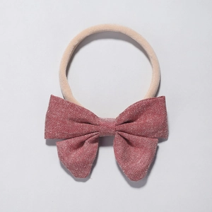 Infant headband with red textured bow and soft nude nylon elastic band for baby girls