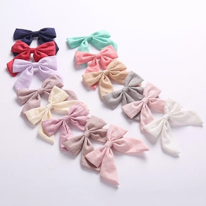 Set of 12 cotton bow hair clips in various Morandi colors with slub texture