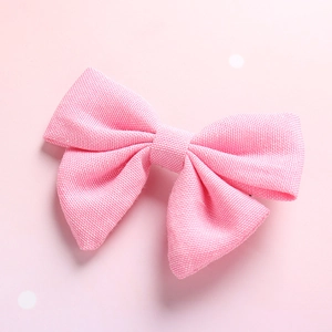 Detailed view of the soft pink cotton linen bow hair clip with ribbed fabric texture