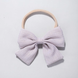Detail of baby nylon headband with khaki striped bow featuring soft elastic material