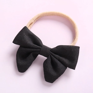Bandeau bébé en nylon doux avec un nœud noir classique pour nouveau-né